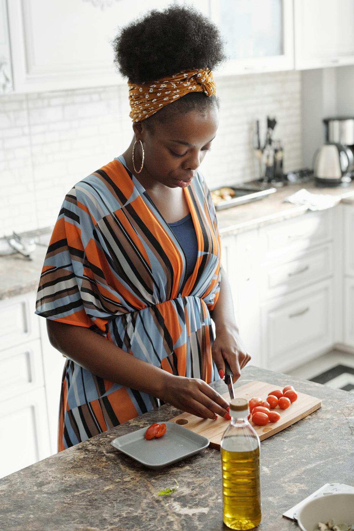 Sarah, a West African home chef stirring jollof rice in her kitchen