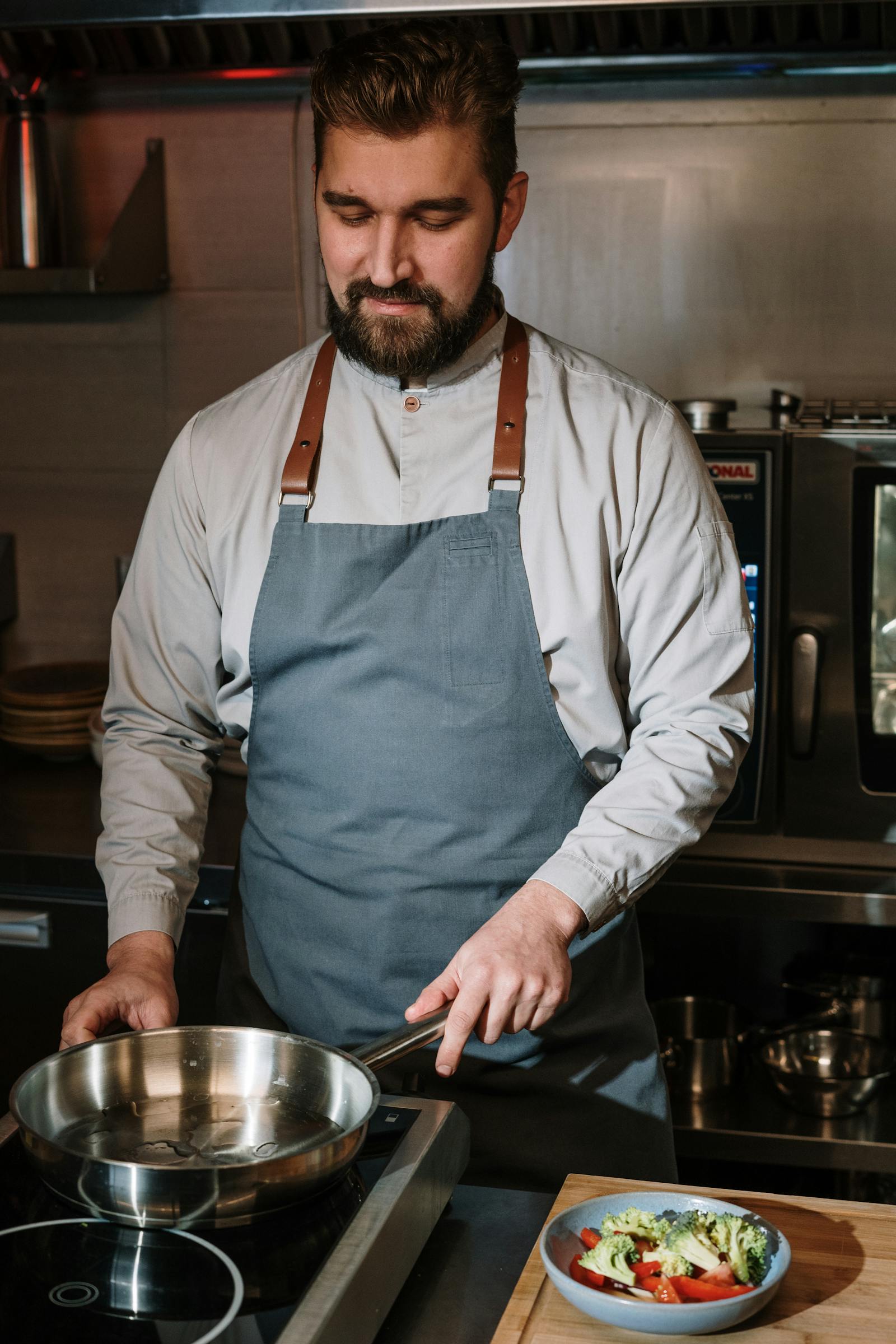A chef cooking in a warm kitchen