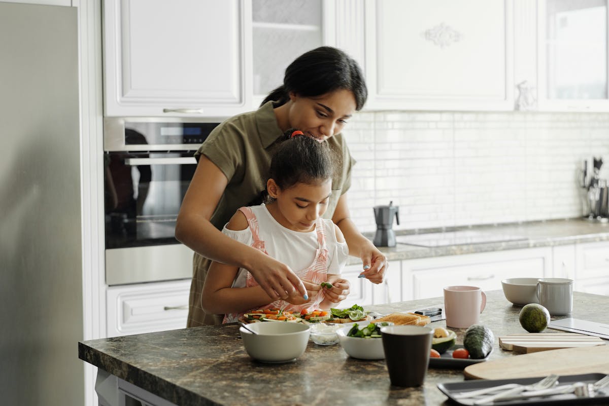 A home cook teaching a child a recipe